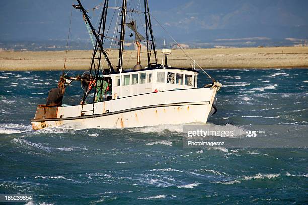 "Small fishing trawler in rough seas, New Zealand"